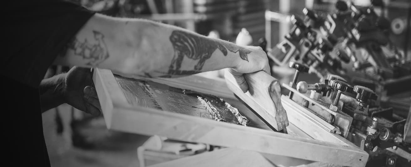 Man doing screen printing.